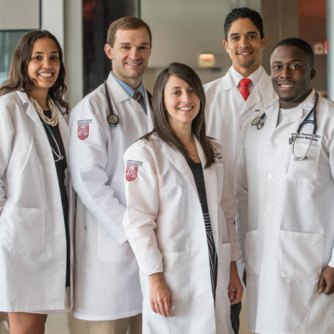 Five physicians posing for a photo